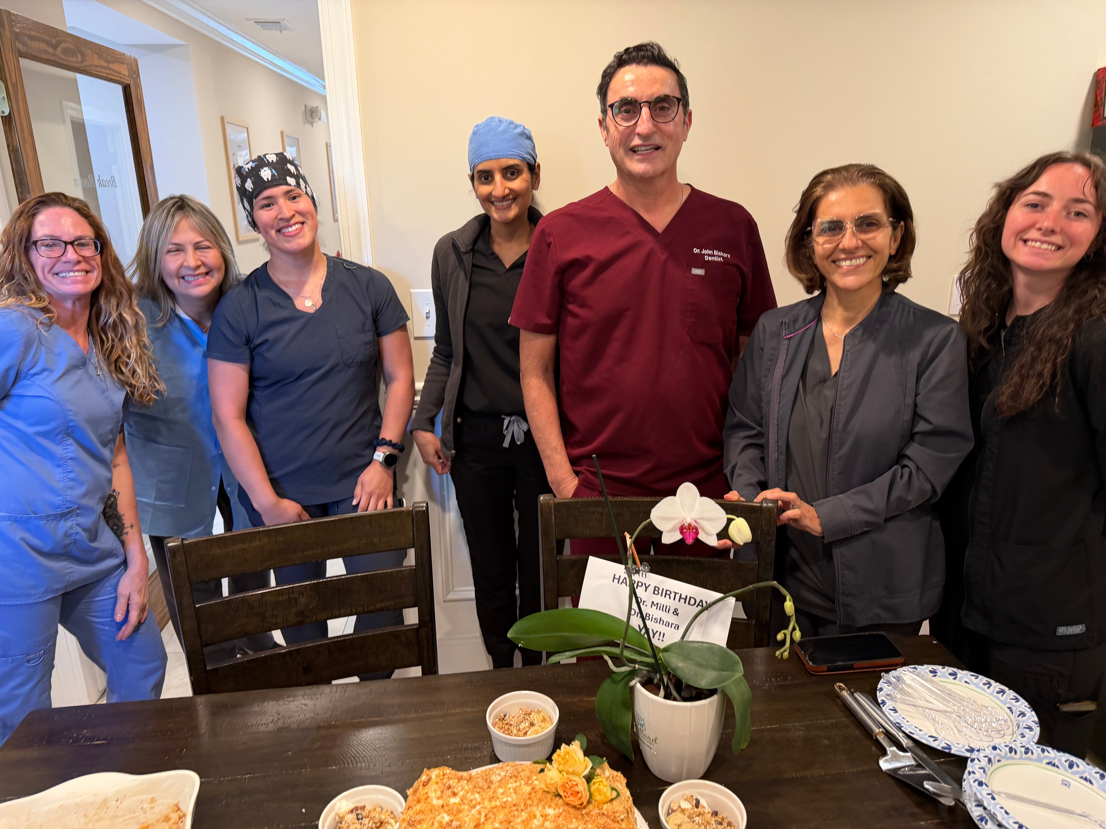 Merchants Walk Dental team celebrating Dr. Bishara and Dr. Patel with cake and decorations