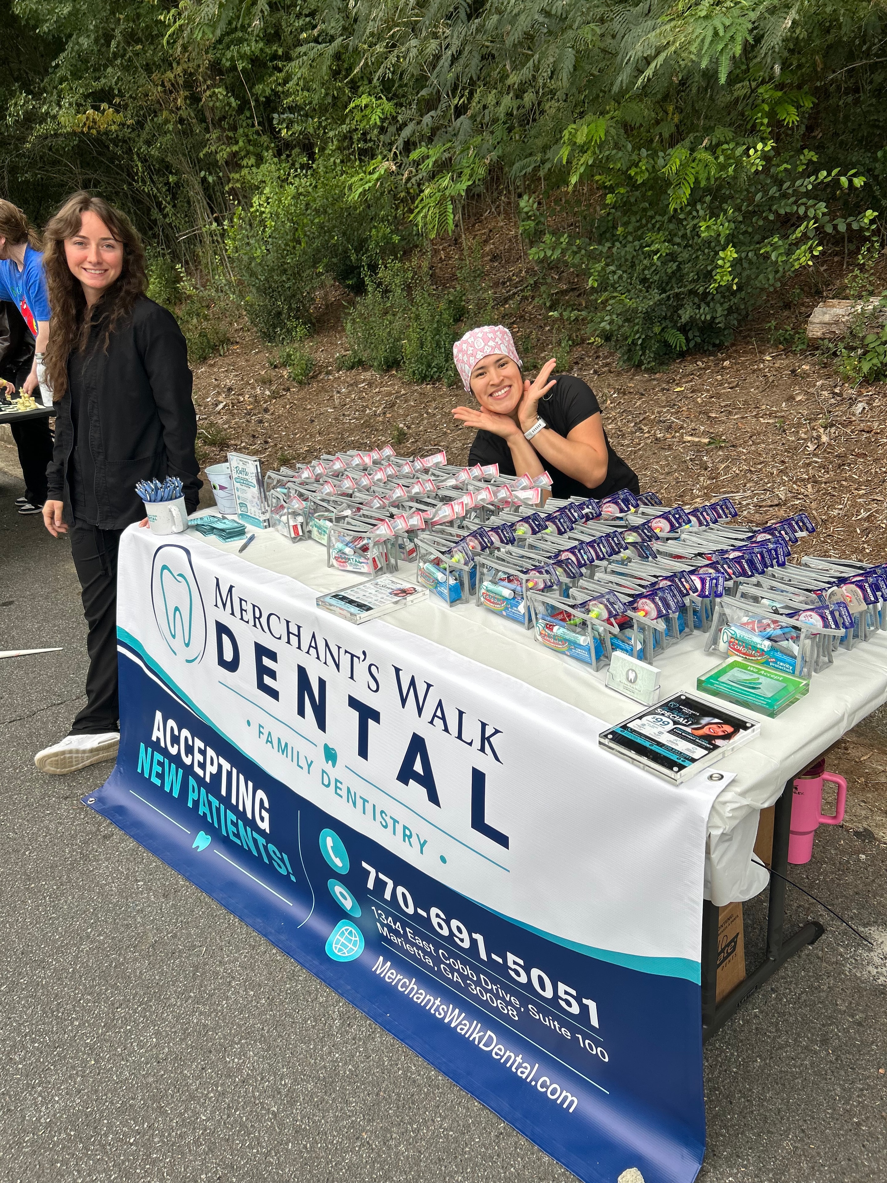 Claudia peeking over the sponsor table with Briana in front at the Timber Ridge Fall Festival