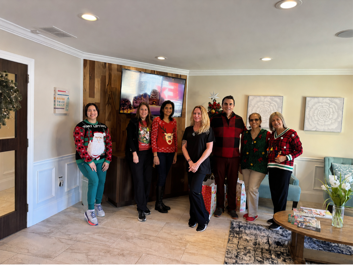 Merchants Walk Dental team in holiday sweaters at the office